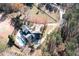 A high angle shows a home's in-ground pool, driveway, and lush, tree-filled landscaping at 355 Clark Creek Pass, Acworth, GA 30102