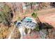 Aerial view of the property featuring a long, winding driveway, mature trees, landscaping, and a pool at 355 Clark Creek Pass, Acworth, GA 30102