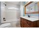 Bathroom featuring a tub-shower, designer tile, and a single sink vanity with storage at 355 Clark Creek Pass, Acworth, GA 30102