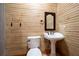 Powder room featuring shiplap wall, pedestal sink and modern fixtures at 355 Clark Creek Pass, Acworth, GA 30102