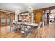 Elegant dining room featuring wood floors, exposed beams, modern lighting, and french doors at 355 Clark Creek Pass, Acworth, GA 30102