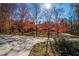 View of the long driveway leading to a beautiful yard with mature trees displaying gorgeous fall colors at 355 Clark Creek Pass, Acworth, GA 30102