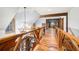 Upstairs hallway with wood floors and wood railings, leading to bedrooms at 355 Clark Creek Pass, Acworth, GA 30102