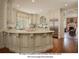 Kitchen with white cabinets and granite countertop, stainless steel appliances. AI modified for white cabinets at 355 Clark Creek Pass, Acworth, GA 30102