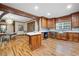 Spacious kitchen featuring wood cabinets, stainless steel appliances, and hardwood floors at 355 Clark Creek Pass, Acworth, GA 30102