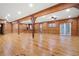 Large living room showcases rustic wood beam supports, hardwood floors and natural light at 355 Clark Creek Pass, Acworth, GA 30102