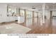 Staged living room and kitchen area with white walls, hardwood floors, and a modern design at 355 Clark Creek Pass, Acworth, GA 30102