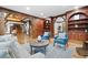 Living room with hardwood floors, wood beams, and built-in shelving, open to dining area at 355 Clark Creek Pass, Acworth, GA 30102