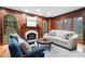 Living room with wood paneling, fireplace, and large windows offering a scenic view at 355 Clark Creek Pass, Acworth, GA 30102