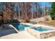 Private pool and hot tub surrounded by well-manicured landscaping and a wooden fence at 355 Clark Creek Pass, Acworth, GA 30102