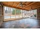 Bright sunroom with stone wall, wood ceiling, and a view of the pool offers a seamless indoor-outdoor experience at 355 Clark Creek Pass, Acworth, GA 30102