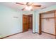 Bedroom with ceiling fan, closet, and door to hallway at 714 Lanford Springs Sw Dr, Lilburn, GA 30047