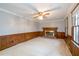 Spacious living room featuring a brick fireplace and wood paneling at 714 Lanford Springs Sw Dr, Lilburn, GA 30047