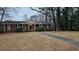 Brick ranch house with a large yard and walkway at 4297 Riverwood Cir, Decatur, GA 30035