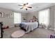 Cozy bedroom features neutral carpet, light walls, and a plush bed with decorative pillows at 180 Paula Dr, Tyrone, GA 30290