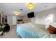 Bedroom with light gray walls, carpet, tv, ceiling lights, and adjoining office space at 180 Paula Dr, Tyrone, GA 30290