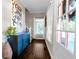 Charming entryway with hardwood floors, statement art, and a convenient storage cabinet at 180 Paula Dr, Tyrone, GA 30290