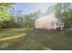 Two-story home with light yellow siding, white trim and mature trees at 180 Paula Dr, Tyrone, GA 30290
