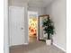 Hallway with light walls, neutral carpet, leading to the bathroom with a colorful shower curtain at 180 Paula Dr, Tyrone, GA 30290