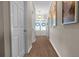 Hallway featuring hardwood floors, neutral walls, and a view of double glass doors at the end at 180 Paula Dr, Tyrone, GA 30290