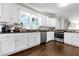 Modern kitchen with white cabinets, granite countertops, and stainless steel appliances at 180 Paula Dr, Tyrone, GA 30290