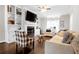 Cozy living room featuring built-in shelves, a fireplace, and neutral-toned furniture at 180 Paula Dr, Tyrone, GA 30290