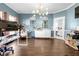 Bright home office featuring wood floors, blue walls, modern lighting, and dual arched built-in shelving units at 180 Paula Dr, Tyrone, GA 30290