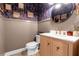 Charming powder room with beadboard, dark floral wallpaper, and a round mirror above a wood vanity at 180 Paula Dr, Tyrone, GA 30290
