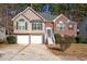 Charming two-story home featuring a brick facade, two-car garage, and beautifully landscaped front yard at 104 Northcutt Station Pl, Acworth, GA 30101