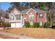 Two-story brick and vinyl home with two-car garage and landscaped yard at 104 Northcutt Station Pl, Acworth, GA 30101