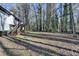Spacious backyard with deck and stairs leading to wooded area at 1900 Mornington Ln, Snellville, GA 30078