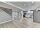 Finished basement with gray walls, wood-look flooring, and a staircase at 1900 Mornington Ln, Snellville, GA 30078