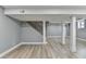 Finished basement featuring gray walls, wood-look flooring, and a staircase at 1900 Mornington Ln, Snellville, GA 30078