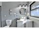 Modern bathroom with white vanity, black accents, and a frameless shower at 1900 Mornington Ln, Snellville, GA 30078