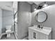 Modern bathroom with grey walls, white vanity, and black accents at 1900 Mornington Ln, Snellville, GA 30078