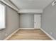 Simple bedroom with grey walls, wood-look floors, and a door at 1900 Mornington Ln, Snellville, GA 30078