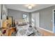Spacious bedroom with hardwood floors, large windows, and neutral decor at 1900 Mornington Ln, Snellville, GA 30078
