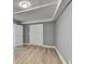 Bright bedroom featuring grey walls, wood-look floors, and double doors at 1900 Mornington Ln, Snellville, GA 30078
