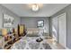 Spacious bedroom with hardwood floors, large windows, and neutral decor at 1900 Mornington Ln, Snellville, GA 30078