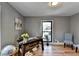 Bright home office features hardwood floors, built-in shelving, and large windows at 1900 Mornington Ln, Snellville, GA 30078