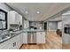 Updated kitchen features granite countertops, stainless steel appliances, and white cabinets at 1900 Mornington Ln, Snellville, GA 30078
