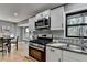 Updated kitchen with granite countertops and stainless steel appliances at 1900 Mornington Ln, Snellville, GA 30078