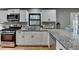 Updated kitchen with granite countertops and stainless steel appliances at 1900 Mornington Ln, Snellville, GA 30078