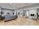 Open living room with hardwood floors, fireplace, and kitchen view at 1900 Mornington Ln, Snellville, GA 30078