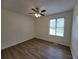 Inviting bedroom featuring new laminate flooring, a ceiling fan and a large window for natural light at 3648 E Melissa Ln, Douglasville, GA 30135