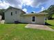 Home exterior featuring a well-maintained yard, patio, and neutral siding, offering great curb appeal at 3648 E Melissa Ln, Douglasville, GA 30135