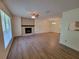 Bright living room with a stone fireplace, laminate floors, a ceiling fan and ample natural light at 3648 E Melissa Ln, Douglasville, GA 30135