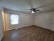 Spacious main bedroom with new laminate flooring, a ceiling fan and a large window for ample sunlight at 3648 E Melissa Ln, Douglasville, GA 30135