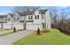 New townhomes featuring modern exteriors, attached garages, and manicured front lawns at 349 Sound Cir, Stockbridge, GA 30281