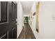 Inviting hallway features wood floors, a stylish mirror, and an open view to the living area at 349 Sound Cir, Stockbridge, GA 30281